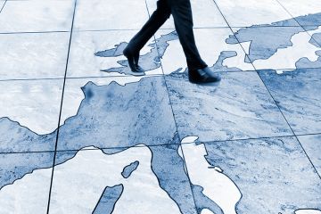 Man walking on a map of Europe, stepping from the UK to Europe. To illustrate that the UK’s Erasmus return is a step in the right direction.