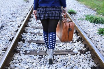 Woman walking alone on railway tracks Woman walking alone on railway tracks