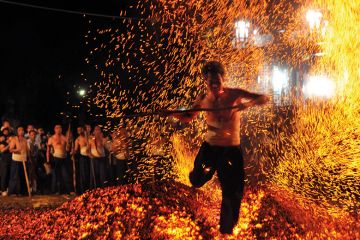 A man walking over burning coals A man walking over burning coals