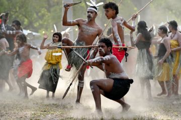 Indigenous Australians perform a cermonial war dance, illustrating culture wars