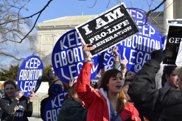 Washington D.C., USA, 22 January, 2015: pro-life woman clashes with pro-choice demonstrators at the U.S. Supreme Court Washington D.C., USA, 22 January, 2015: pro-life woman clashes with pro-choice demonstrators at the U.S. Supreme Court