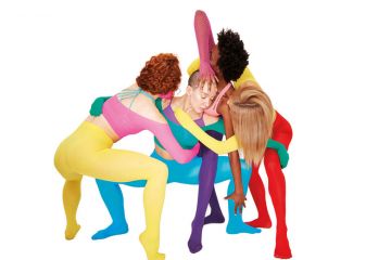 Four women with their arms artistically around each other