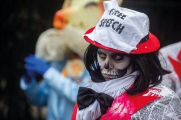 Protester wearing free speech hat in London Protester wearing free speech hat in London to illustrate The free speech bill has finally become law - what happens next?