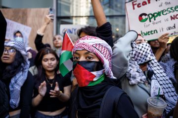 Students from Hunter College chant and hold up signs during a pro-Palestinian demonstration at the entrance of their campus. Students from Hunter College chant and hold up signs during a pro-Palestinian demonstration at the entrance of their campus to illustrate Israeli war revives academic freedom turmoil on US campuses