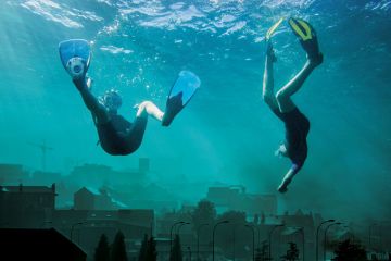 Montage of two people underwater in the cityscape of Sheffield city centre, England to illustrate The joys  and trials of homecomings