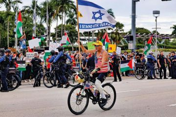 A pro-Israel protestor rides his bike along Biscayne Blvd A pro-Israel protestor rides his bike along Biscayne Blvd to illustrate US campuses confront extent of donor influence after Israel rows