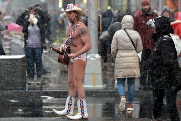 Street performer Naked Cowboy walks through the snow on Time Square to illustrate Open science funding cuts leave us ‘unprepared’ for next pandemic