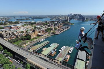 Two people abseil down the side of the Australian insurance and financial giant AMP's headquarters in Sydney Two people abseil down the side of the Australian insurance and financial giant AMP's headquarters in Sydney to illustrate Elite university diversity drive raises Australian eyebrows