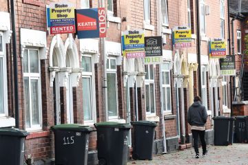 A man walks past a street of terraced houses advertising properties A man walks past a street of terraced houses advertising properties to illustrate Average student rents now eat up all of maintenance loan – survey