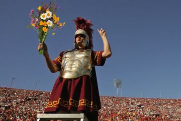 A USC Trojans mascot and the band cheer during the game with the Washington State Cougars to illustrate Waning powers