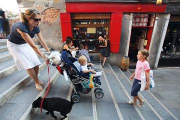 A mother carries a pram up some stairs A mother carries a pram up some stairs to illustrate ‘Grant us flexibility’