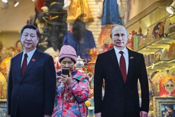 A tourist stands next to cardboard images depicting Chinese President Xi Jinping (L) and his Russian counterpart Vladimir Putin at the touristic Arbat street in downtown Moscow A tourist stands next to cardboard images depicting Chinese President Xi Jinping (L) and his Russian counterpart Vladimir Putin at the touristic Arbat street in downtown Moscow to illustrate Russian research is ‘increasingly isolated’ by Ukraine conflict