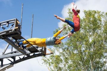 Performers launch themselves off the Imagineer Bridge in Warwick to illustrate ‘Contagion’ risk if UK university goes under, warns report