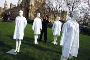Group of unused laboratory coats and mannequins at Westminster, Central London to highlight the fact that the Government is cutting funding from the national research budget to illustrate Anger as social sciences lose cash to STEM under REF rule change