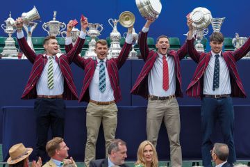 Line of winners holding up their trophies to illustrate Oxford Covid vaccine windfall outweighs rest of sector IP income