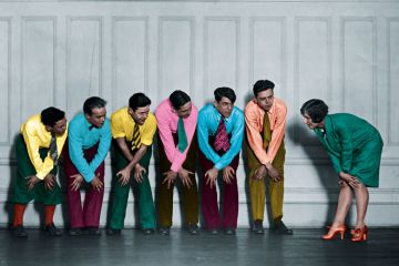 Rehearsal of a show of a group in a line holding their knees to illustrate For academia and policymakers, relationships are key to impact