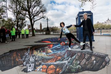 Peter Capaldi, (The Doctor) and Pearl Mackie (Bill) pose in front of the TARDIS to illustrate My favourite  fictional academic