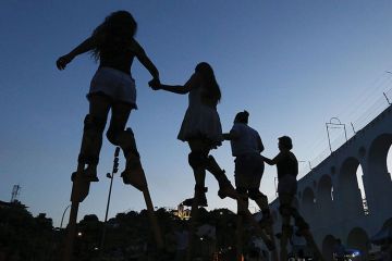 People practice walking on stilts during a stilt walking workshop as part of pre-Carnival festivities People practice walking on stilts during a stilt walking workshop as part of pre-Carnival festivities