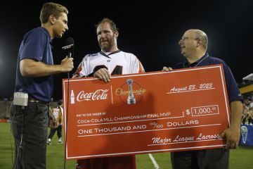  Major League Lacrosse Commissioner hands a check after the game in Kennesaw, Georgia to illustrate Most institutions lose out as US college sports professionalise