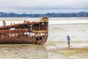 Tourist photographs the Janie Sedan Shipwreck, New Zealand, Oceania, South Island Tourist photographs the Janie Sedan Shipwreck, New Zealand, Oceania, South Island to illustrate New Zealand funding model ‘not fit for purpose’