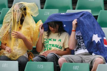 Spectators take temporary cover as rain stops play Spectators take temporary cover as rain stops play to illustrate Government will pilfer international levy proceeds, critics warn