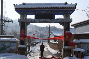 Residents stand at the entrance to Beicibeiyu village, blocked off Residents stand at the entrance to Beicibeiyu village, blocked off to illustrate Experts doubtful as China launches new open access push