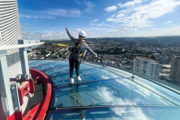  A visitor to British Airways i360 Viewing Tower in Brighton standing on the skywalk to illustrate TPS: universities seek respite from £125 million pensions bill