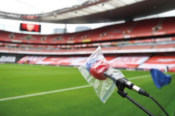  A microphone is covered from the rain pitchside to illustrate University postpones free speech event, over free speech concerns