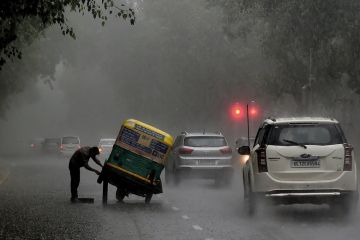 An Indian auto rickshaw driver tries to repair his vehicle after it broke down in heavy rain in New Delhi An Indian auto rickshaw driver tries to repair his vehicle after it broke down in heavy rain in New Delhi to illustrate Graduate unemployment emerges as Indian election issue