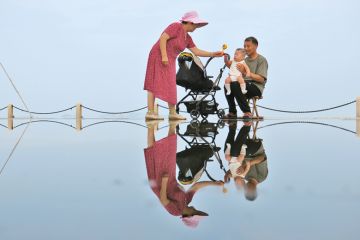 An elderly couple tease their grandson in Yantai, Shandong Province of China An elderly couple tease their grandson in Yantai, Shandong Province of China to illustrate Ten years to prepare for demographic cliff edge, China warned