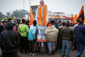 Devotees gather near an effigy of Indian prime minister Narendra Modi at the Ram Mandir Temple Devotees gather near an effigy of Indian prime minister Narendra Modi at the Ram Mandir Temple to illustrate Political attacks on Indian HEIs must end