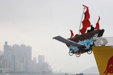 A participant sits in his structure that features a traditional Chinese fishing boat at the Red Bull Flugtag (flight day) competition on a cloudy day in Hong Kong to illustrate Opaque investigation fails to clear clouds over HKU council
