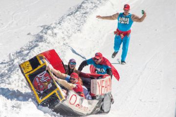 Participants react after sledding down the mountain and crashing their Duff Brothers themed sled  in Scranton, Pennsylvania, to illustrate NCAA bankruptcy would ‘reshape college sports landscape’