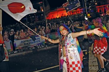 Person waving Japanese flag in Sydney Australia at the annual Sydney Gay and Lesbian Mardi Gras Parade Person waving Japanese flage in Sydney Australia at the annual Sydney Gay and Lesbian Mardi Gras Parade to illustrate Japan moves cautiously on overseas branch campuses