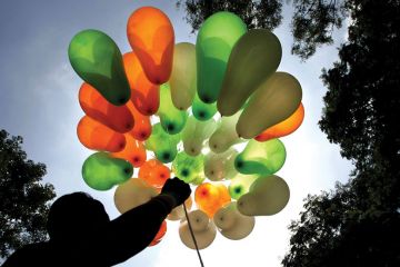 A vendor displays his stock of balloons in the tri-colours of the national flag on a street in Bangalore. A vendor displays his stock of balloons in the tri-colours of the national flag on a street in Bangalore.