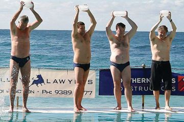 People carry ice blocks as they prepare to get into the pool next to the Pacific Ocean at Bondi Beach in Sydney. People carry ice blocks as they prepare to get into the pool next to the Pacific Ocean at Bondi Beach in Sydney.