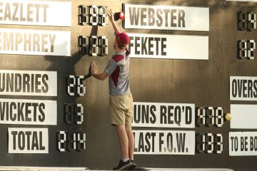 A scorer adjusts the scoreboard in Brisbane, Australia A scorer adjusts the scoreboard in Brisbane, Australia