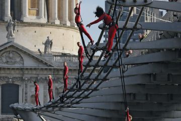 Dancers bungee off the Millennium Bridge, London, UK to illustrate nearly nine in 10 are facing job cuts