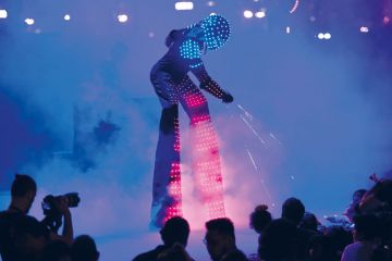   A man in a robot costume performing to illustrate ‘ChatGPT-generated reading list’ sparks AI peer review debate