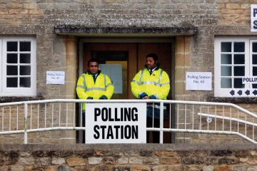 Security staff stand at the polling station Security staff stand at the polling station to illustrate I’m a bouncer, but don’t ask me to evict students from polling booths