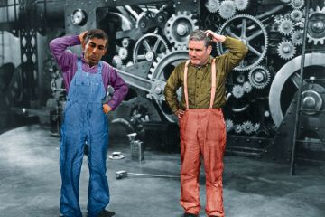 Rishi Sunak and Keir Starmer montage on a film still image of machinery Rishi Sunak and Keir Starmer montage on film still scratching their heads to illustrate System engineering