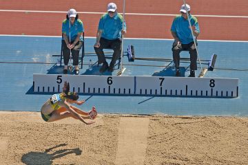 Australia's Lisa Morrison competes in the Women's Long Jump with a measure stick next to her to illustrate Don’t scale back research quality criteria, Australian universities say