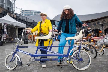 Two ladies in vintage clothing pose with a tandem Raleigh Chopper in Granary Square, Kings Cross Two ladies in vintage clothing pose with a tandem Raleigh Chopper in Granary Square, Kings Cross to illustrate ‘Shut gender pay gap with v-c job-shares’