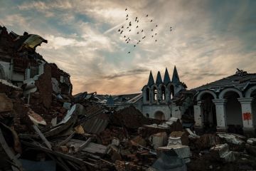  A flock of birds fly over a destroyed church at the skete of St. George’s Monastery in Dolyna, Ukraine