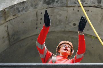 Civil engineer working on a wide concrete tunnel to illustrate Raac closures and disruption ‘worst case scenario’ as term begins