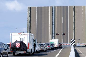 Cars are stopped by a draw-bridge on the A6 Highway near Swifterbant, Netherlands Cars are stopped by a draw-bridge on the A6 Highway near Swifterbant, Netherlands to illustrate Dutch universities unveil plan to limit international enrolments