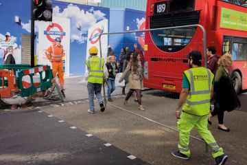 Workman carry a construction fence across Oxford Street in central London. Workman carry a construction fence across Oxford Street in central London to illustrate Shift to relationship bans ‘signals new approach in universities’