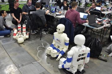 People gathered in Sydney for the annual RoboCup event People gathered in Sydney for the annual RoboCup event to illustrate AI potential ‘squandered by universities’ risk-focused approach’