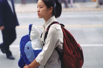 Chinese lady holding toy whale Chinese lady holding toy whale