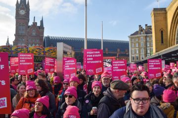 Protesters hold UCU strike placards during a rally to illustrate Pay must be sustainable for institutions rich and poor, v-cs say